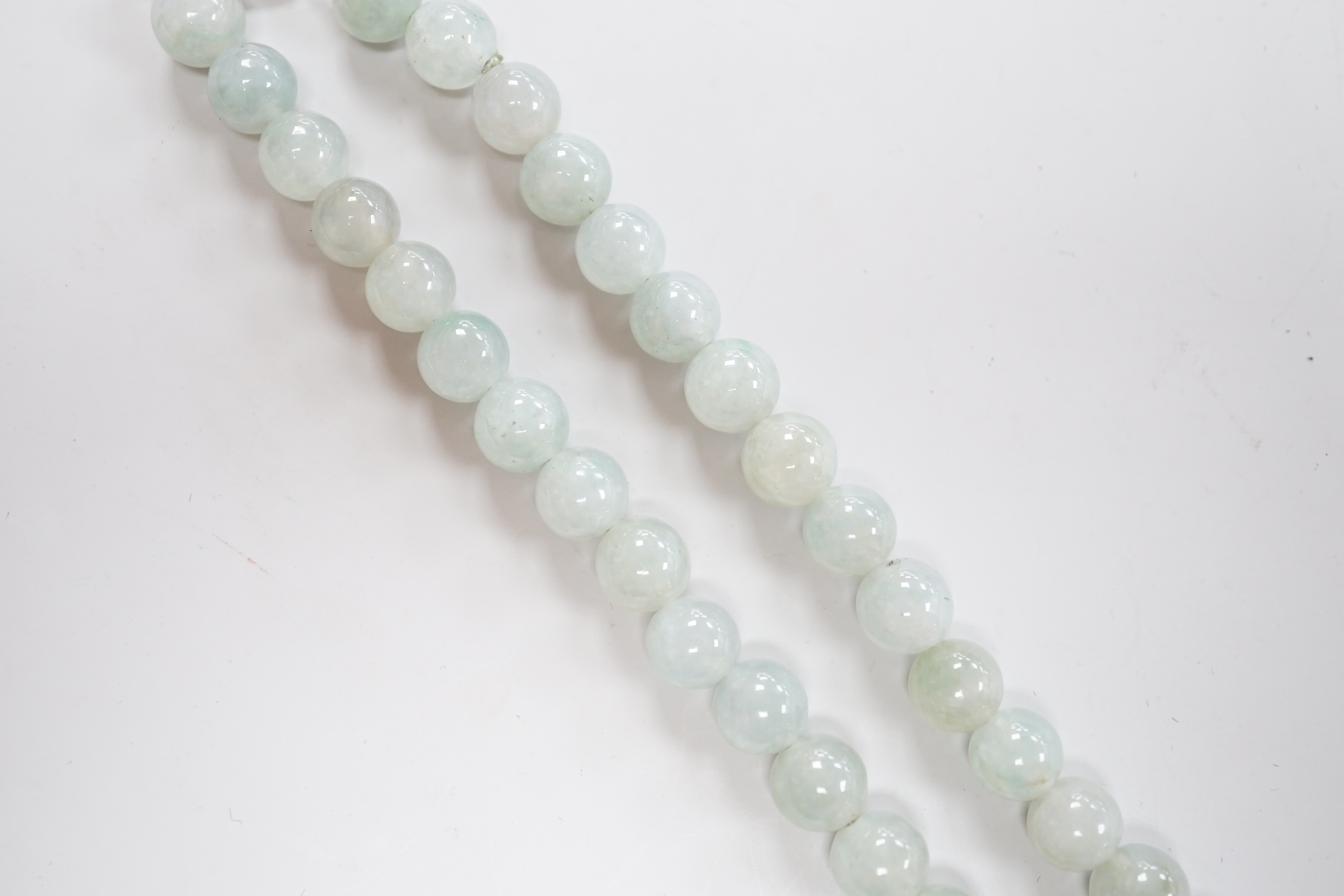 A single strand jadeite bead necklace, with 18k clasp, 43cm, gross weight 58.7 grams, with accompanying Gem & Pearl Laboratory report dated 18/03/2019, stating the jade to have no evidence of treatment.